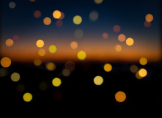 Аbstract bokeh background. Abstract defocus background. Festive, Christmas, New Year background. Bokeh. Defocus lights. Night. Sunset. A garland on the window.