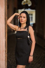 Obraz na płótnie Canvas Beautiful young black hair woman walking on the summer street of old town in summer