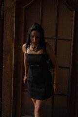 Beautiful young black hair woman walking on the summer street of old town in summer