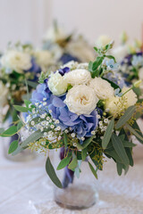 Flower bouquets for the brides maids with white roses and blue flowers