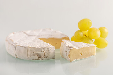 fresh delicious brie cheese and grapes close up shallow depth of field