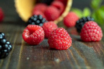 Ripe red raspberries in a crispy waffle cone