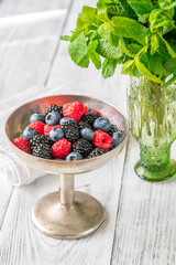 Fresh berries in silver vase