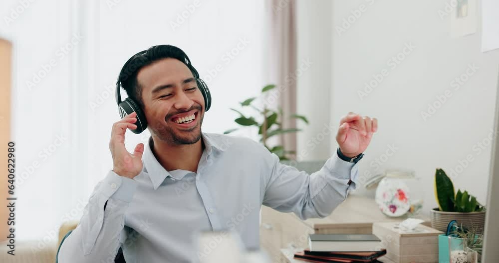 Wall mural Dance, singing and a man with music during remote work for fun during business or online job. Happy, enjoying and a freelance Asian employee or entrepreneur with headphones in a home for audio