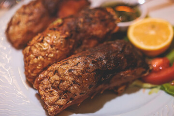Fried grilled carp, roasted carp fish on plate with lemon and salad served in a traditional restaurant in Montenegro, Skadar lake, prepared cooked crucian carp steak, balkan dish, Montenegrin cuisine