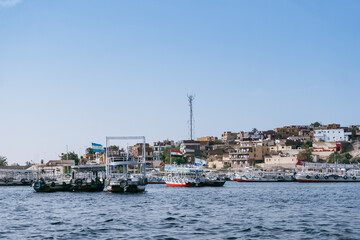 Fototapeta premium Egypt Summer Travel Tranquil Waterside Haven: Boats in a Nile River Village