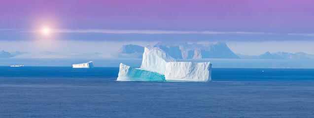 Iceberg seen from cruise ship vacation near Greenland coast in Arctic circle near Ilulissat Disko Bay. © eskystudio