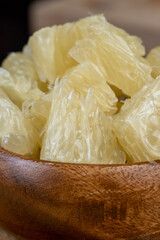 peeled pomelo on the table, close up