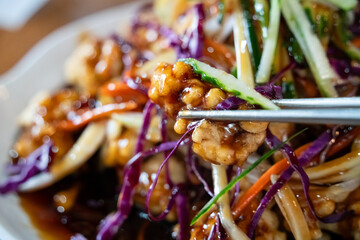 Delicious sweet and sour sauced deep fried pork, Tangsuyuk, with vegetables.