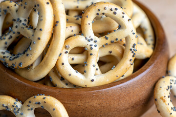 Poppy seed coating dried bagels on the table