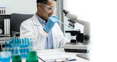 Science and medicine, scientist analyzing and dropping a sample into a glassware, experiments containing chemical liquid in laboratory on glassware, innovative and technology.