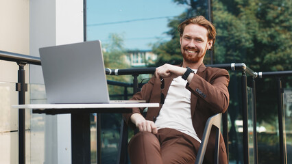 
Portrait of a handsome charismatic red-haired bearded businessman in a formal suit. A male...