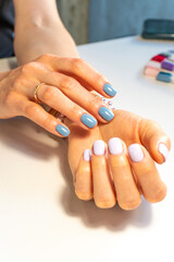 Hands of a young woman with a beautiful manicure on a white background. nail