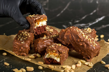 Chocolate sticks with peanuts on a dark background