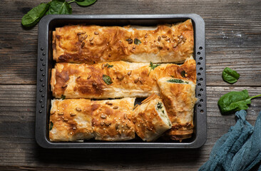 Freshly baked rolled pie with spinach.
