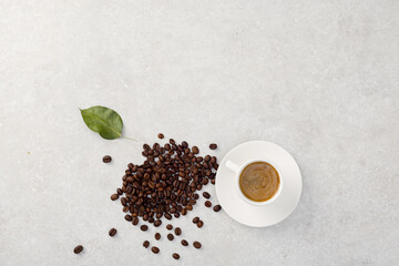 A cup of coffee and coffee beans on the table. .