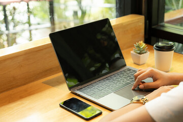 business woman sitting at desk with professional expression sitting at work with a tablet in hand occasional sip of coffee and manage mobile phones attentively. efficiently juggling her tasks staying.