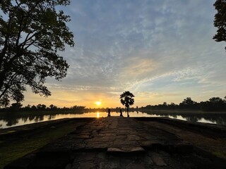Fototapeta na wymiar Sunrise seen from an artificial pond built for the king's ablution, Srah Srang, Angkor ruins, Siem Reap, Cambodia
