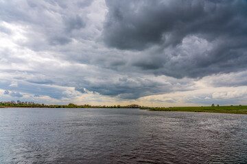 Beautiful imposing clouds above the river De Lek near Beusichem, the Netherlands