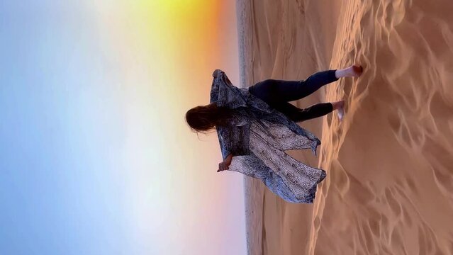 Beautiful woman in the desert during sunset. High quality FullHD footage