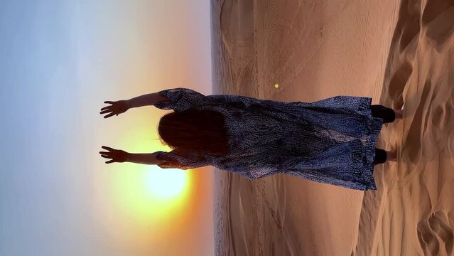 Beautiful woman in the desert during sunset. High quality FullHD footage