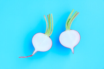 Fresh radish sliced half on blue background, Organic vegetable