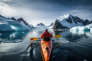 Tuinposter lonely journey to island of ice winter kayaking in antarctica. sports, cold and glaciers in the ocean © Svetlana