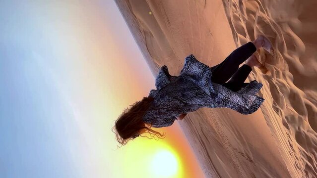 Beautiful woman in the desert during sunset. High quality FullHD footage