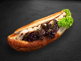 Grilled chicken lula kebabs in a bun with lettuce and sauce. . Isolated on a dark background