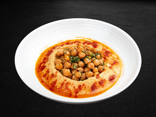 Chickpea hummus with smoked paprika. Isolated on a dark background