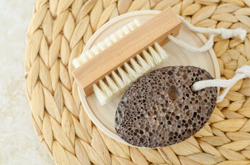 Black volcanic pumice stone and massage foot brush with natural bristles. Eco friendly toiletries. Homemade spa and pedicure concept.