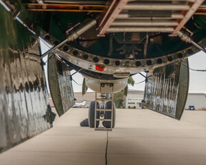 view underneath B-29 Superfortress with bomb bay doors open and forward lower gun turret visible