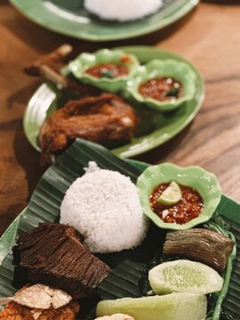 Banyuwangi typical tempong rice with fried chicken, empal meat, vegetables and chili sauce