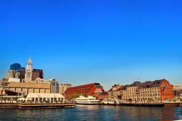 Architectural Symphony_Varied Buildings Amidst Serene Waters and Blue Skies