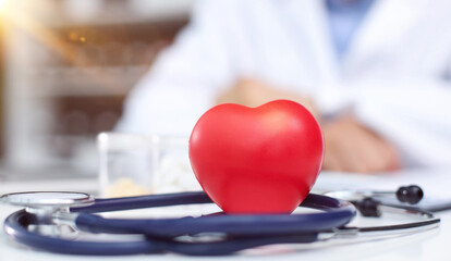 Obraz na płótnie Canvas Stethoscope, red heart and cardiogram on gray table. Cardiology concept