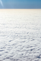 View from the plane from above on the veil of clouds