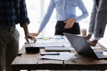 Financial analysts analyze business financial reports on a digital tablet planning investment...