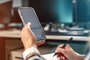 Writing notes on the phone in the office