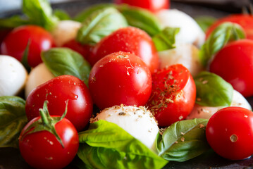 Caprese salad with mozzarella cheese and tomatoes of Italian cuisine