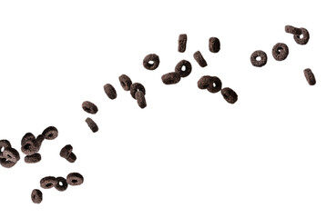 Chocolate rings cereal spill out into a bowl. Breakfast.