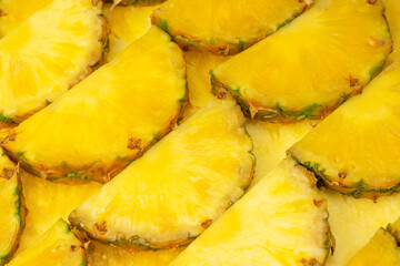Pineapple juicy yellow slices as a background.