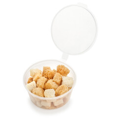 Portioned croutons in a plastic container isolated on a white background.