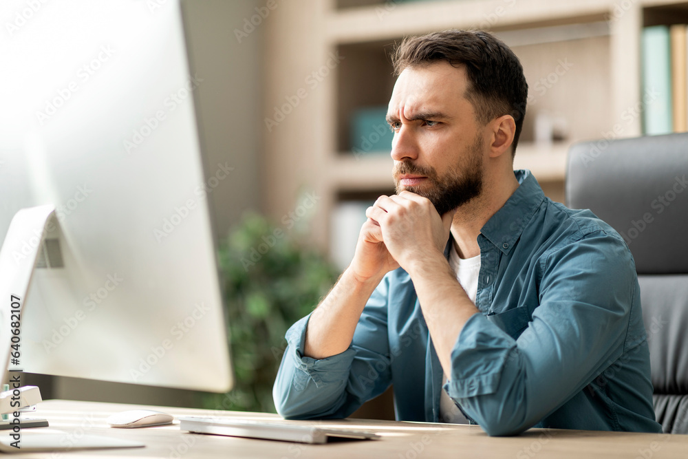 Poster Focused Businessman Looking At Computer Screen While Working At Desk In Office