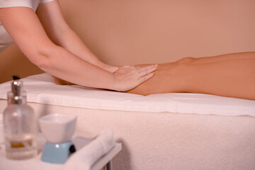 Obraz na płótnie Canvas osteopath gently relaxes woman legs in medical center or spa salon