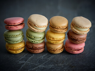 Colorful sweet macaroons on table