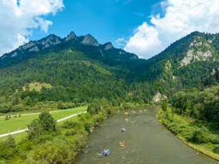 Rafts and canoes approaching Dunajec River Gorge and Trzy Korony Mountain in Poland