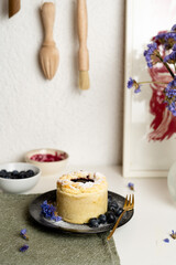 Almond stuffed tart with blueberries jam on top and powdered sugar