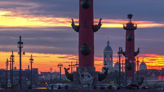 Sunset timelapse over Strelka - Spit of Vasilyevsky Island with Old Stock Exchange and Rostral Columns in Saint Petersburg, Russia, under a beautiful cloudy sky