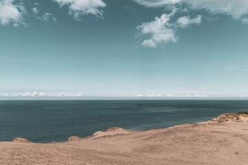 Sand dunes and seascape next to Rubjerg Knude Lighthouse.