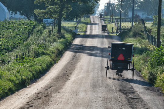 Three Amish buggies Early Morning